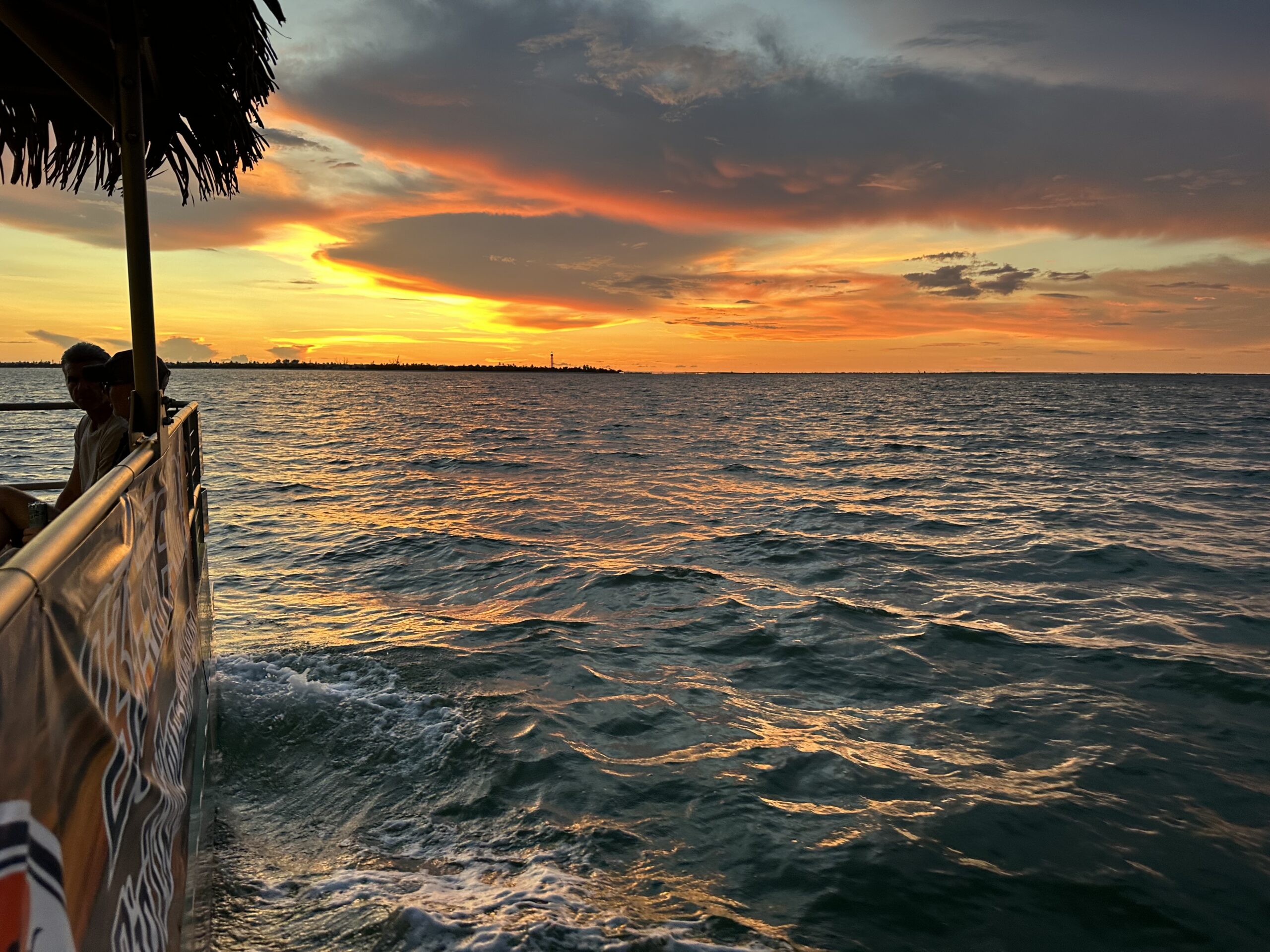 18-passenger tiki boat cruising in Fort Myers Beach