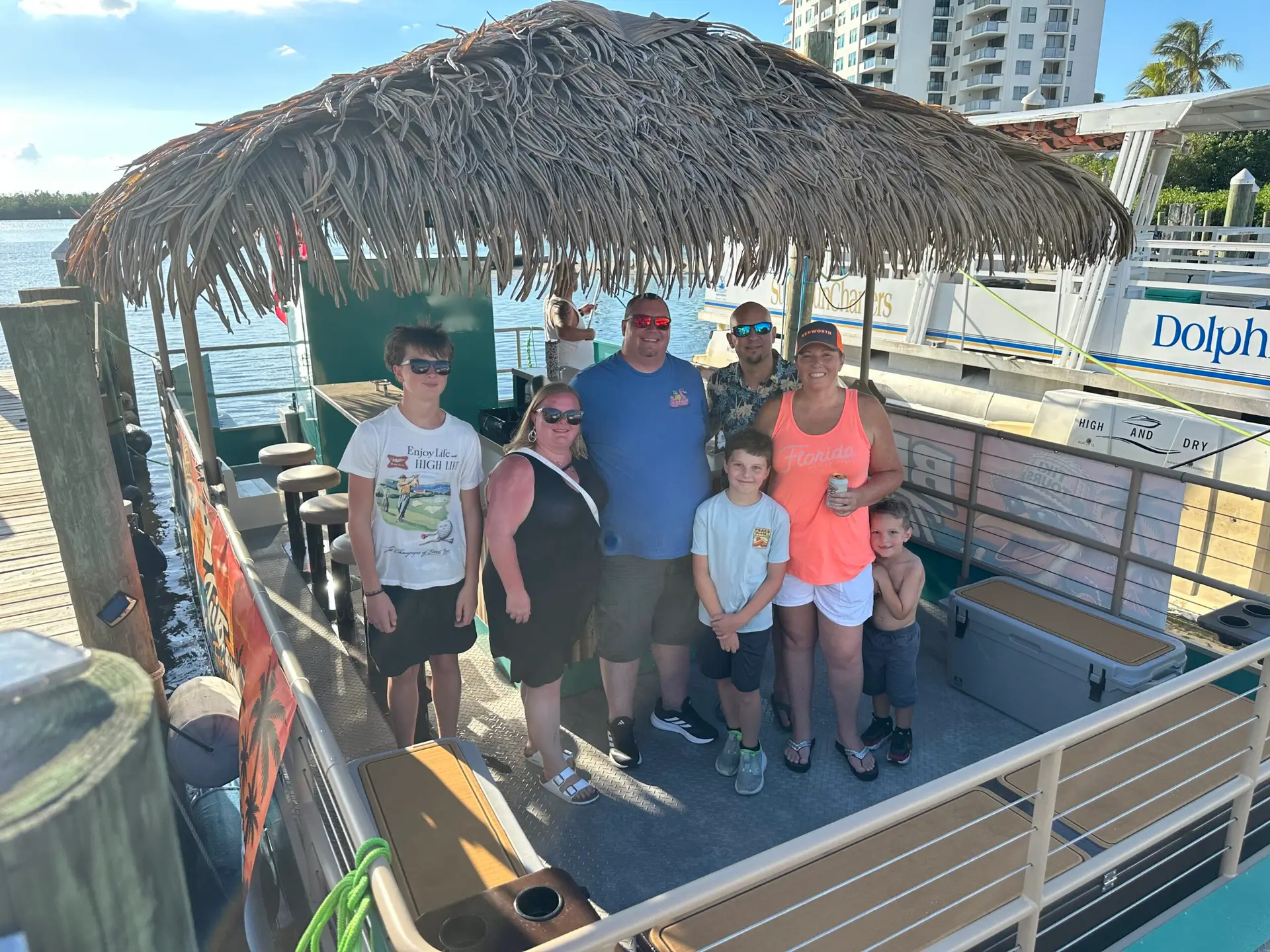 Guests standing aboard the 18-passenger tiki boat at the dock